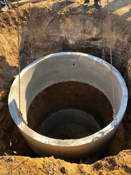 Установка бетонных колец в яму